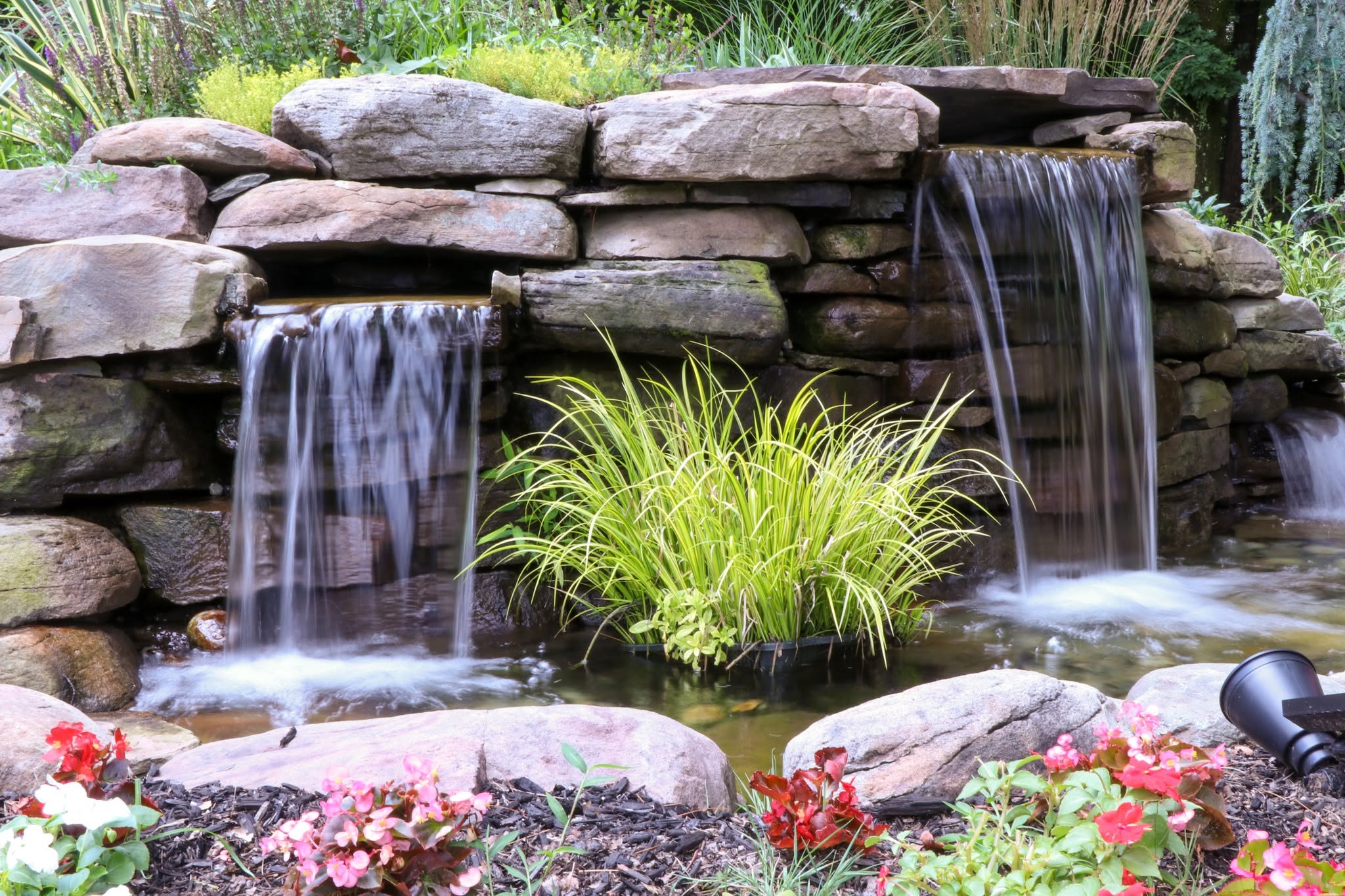 two waterfalls into a small pool of water